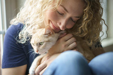 Americat Company founder Diane Danforth hugging her cat